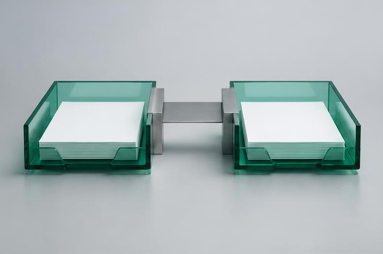 Two emerald document trays joined by a silver bridge.